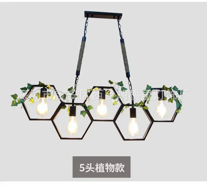 Black industrial style pendant light with brass hexagonal frame five exposed bulbs and green ivy decorbites industrial style