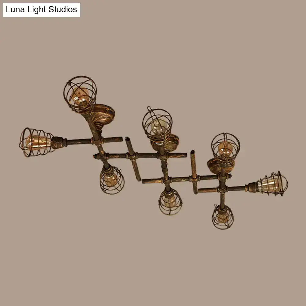 Industrial brass intersecting piping ceiling light with six exposed filament bulbs in wire cages for dining room use