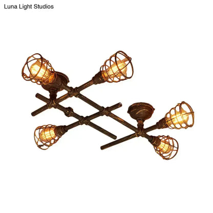 Industrial brass intersecting piping ceiling light with four filament bulbs in bronze wire cage for dining room use