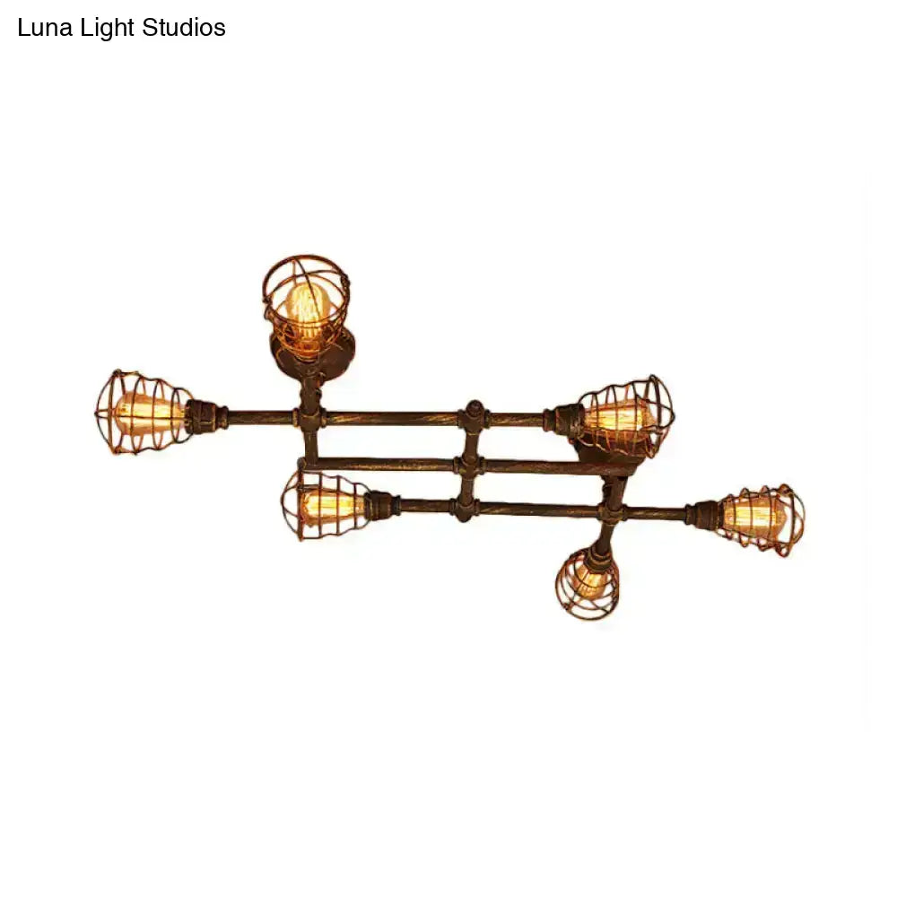 Industrial brass intersecting piping ceiling light with five exposed filament bulbs in dark bronze wire cages for dining room