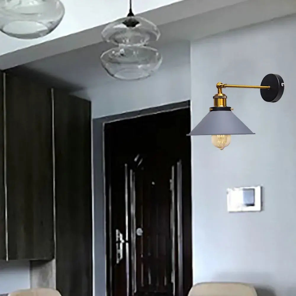 A sleek modern industrial brass led wall lamp with a matte gray conical shade for bedroom sconce lighting