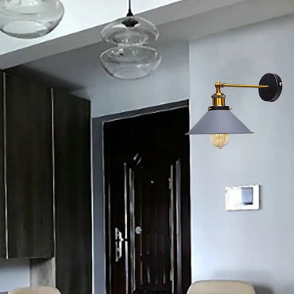 A sleek modern industrial brass led wall lamp with a matte gray conical shade for bedroom sconce lighting