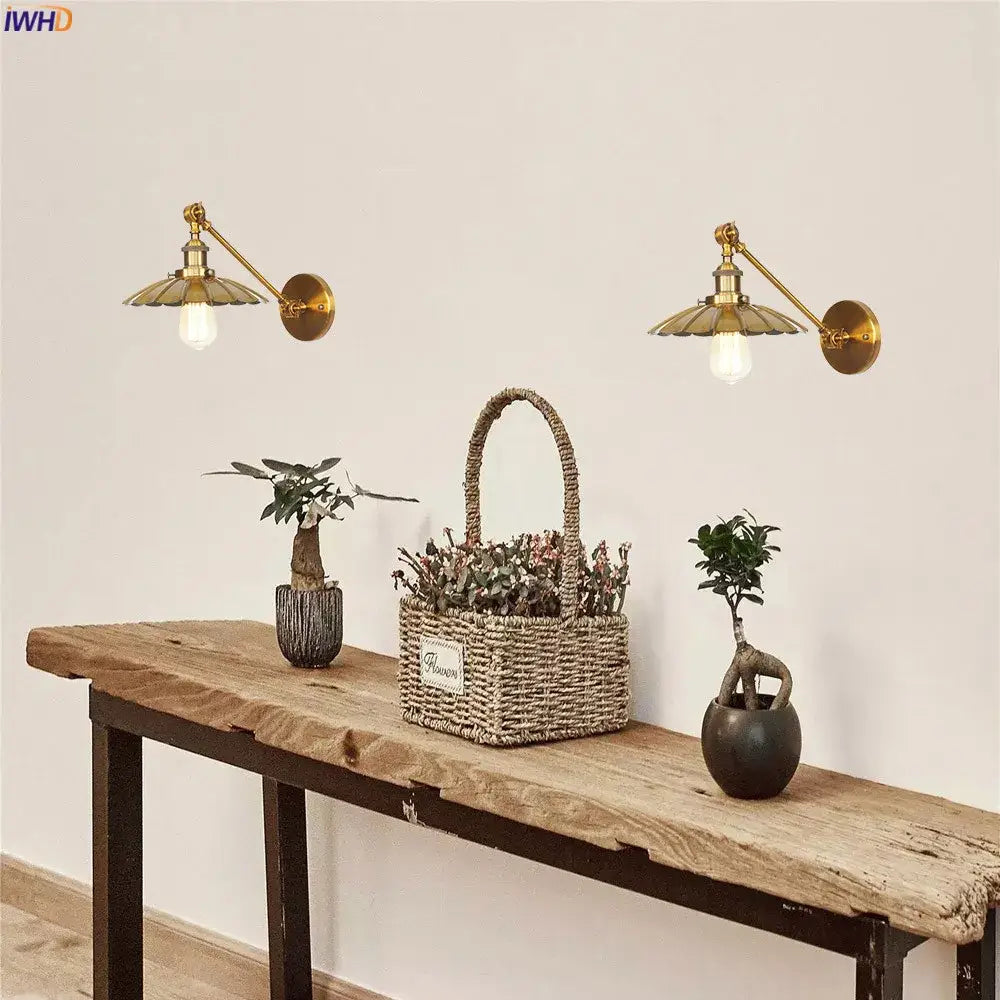 Pair of industrial brass long arm led wall light bedroom sconces with fluted shades and exposed bulbs mounted on the wall