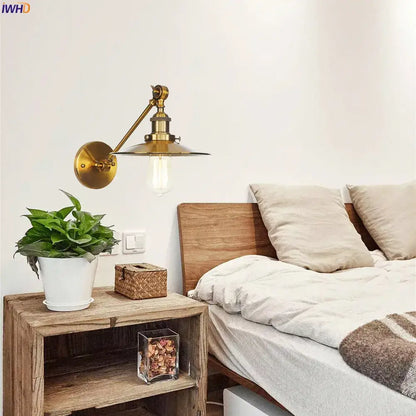 Industrial brass long arm led wall light featuring an adjustable arm and vintage edison bulb for bedroom use