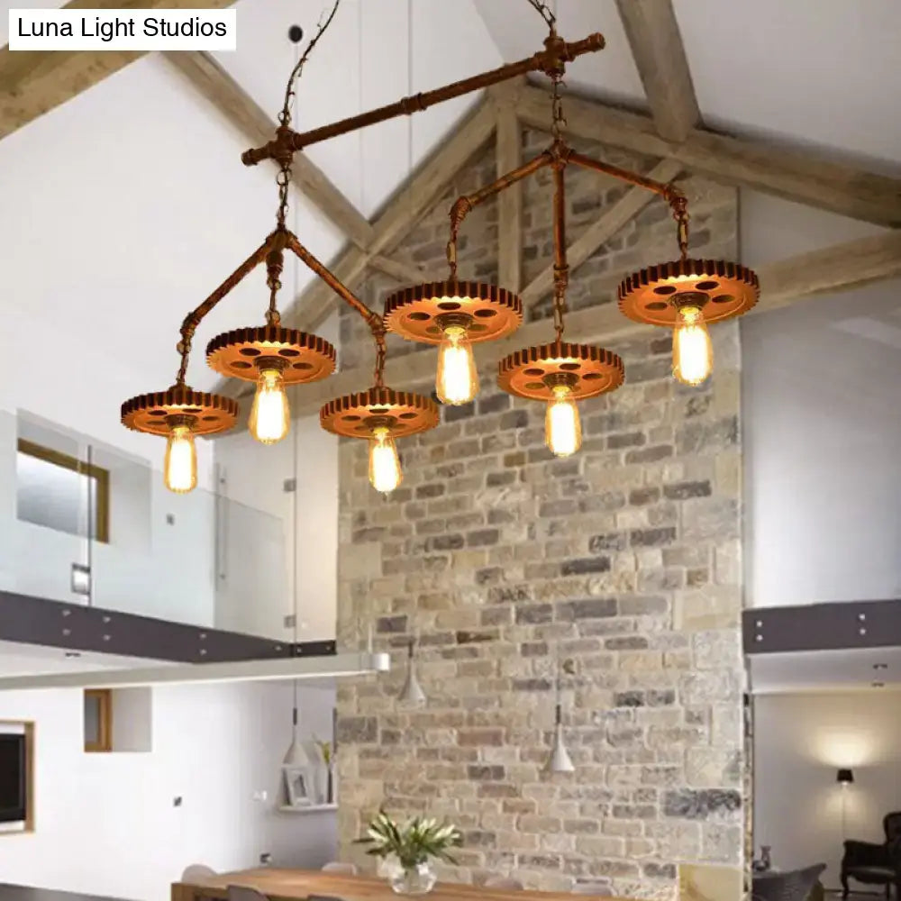 Industrial brass pipe island light fixture featuring rust finish metal pipes and gear shades with exposed bulbs