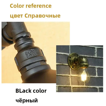 Industrial brass pipe wall sconce featuring black iron pipe and vintage brass mounting bracket with exposed filament bulb
