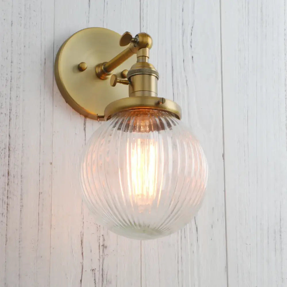 Brass-finished wall sconces featuring industrial ribbed glass globe for kitchen light decorbites industrial ribbed design