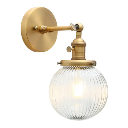 Brass-finished wall sconce with industrial ribbed glass globe for kitchen light decorbites industrial ribbed design