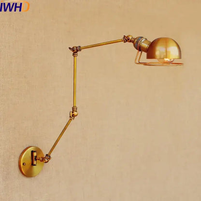 Brass-finished adjustable industrial led wall lamp with dome-shaped shade and articulated arms for bedroom reading light