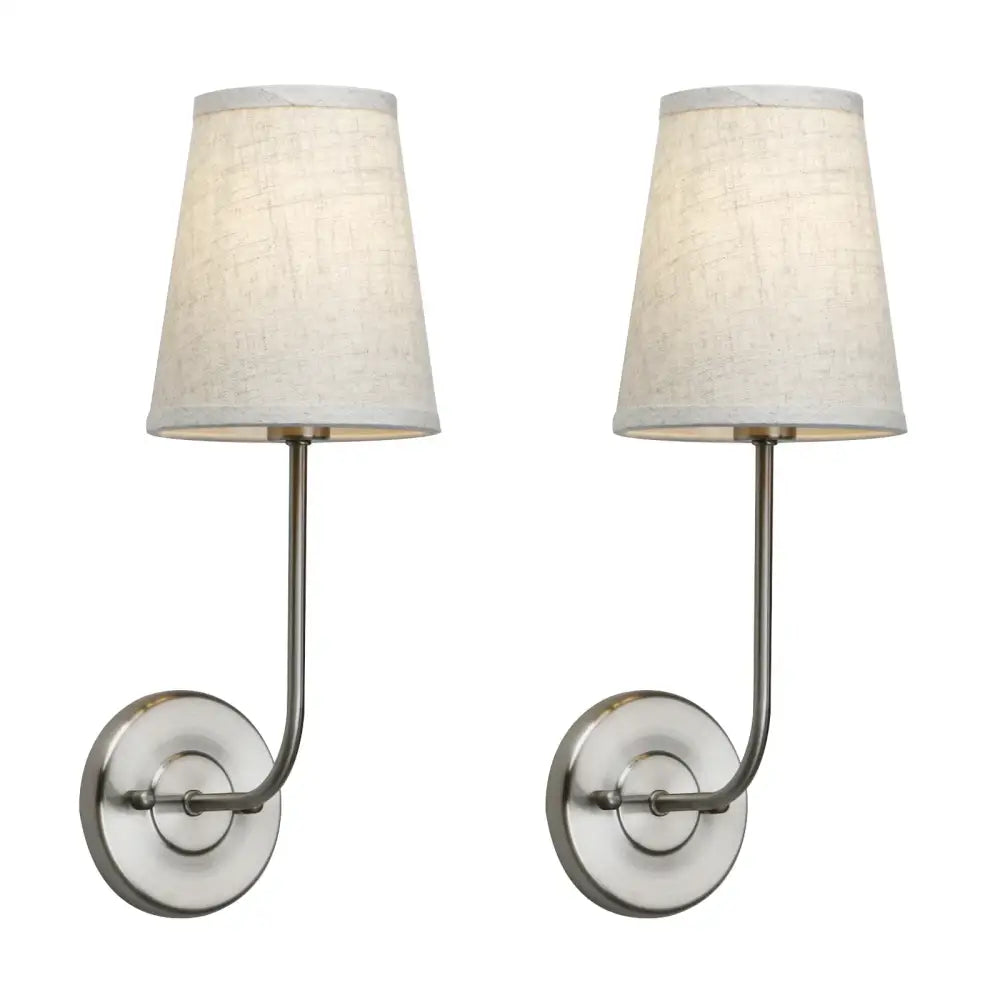 Pair of brushed nickel wall lamp set with off-white linen shades for industrial bedroom reading light
