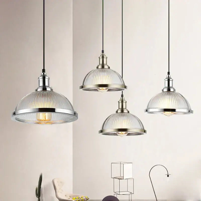 Industrial brushed nickel pendant light with ribbed glass shade designed for dining room use