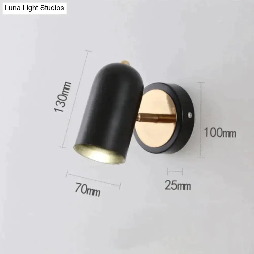 Black cylindrical industrial led wall sconce with brass base and adjustable arm for bedroom spotlight lighting