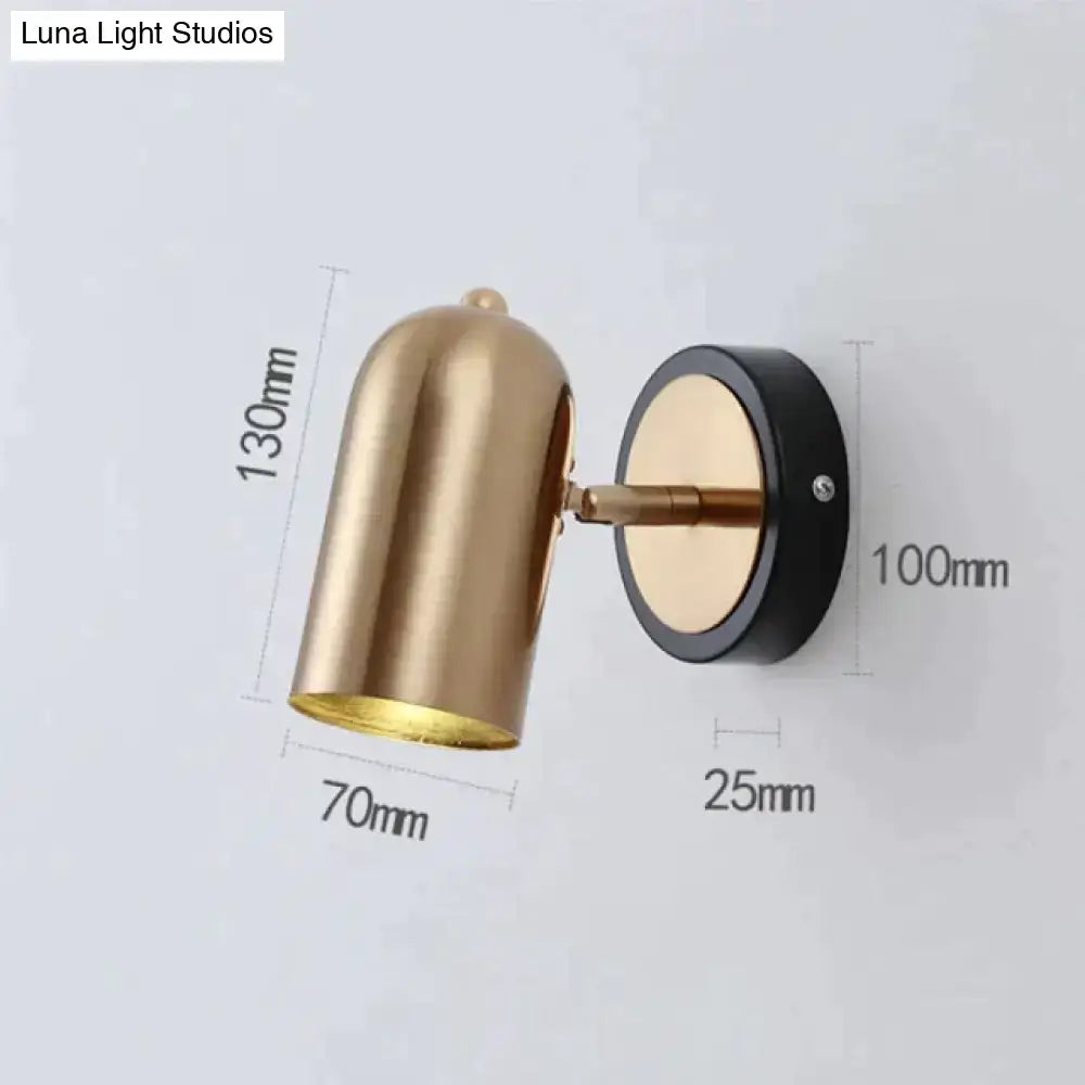 Gold-toned industrial led wall sconce with sleek finish black base and adjustable arm for bedroom spotlight lighting