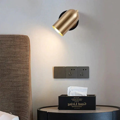Gold-finished industrial led wall spotlight with cylindrical shape, adjustable head, and sleek metallic finish for bedroom use