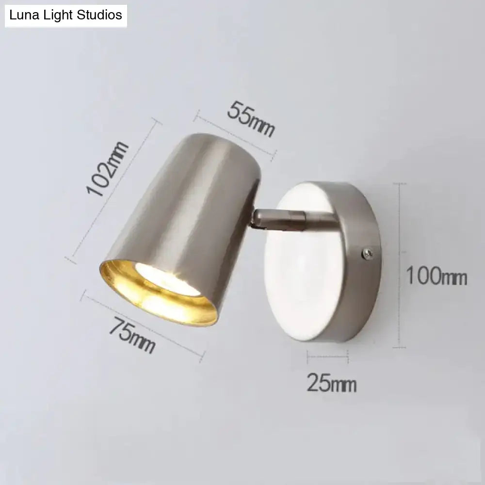 Modern brushed stainless steel industrial led wall sconce with a sleek cylindrical head and gold-toned interior spotlight