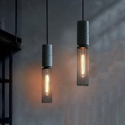 Industrial cement metal pendant light with concrete tops and mesh cages featuring glowing filament bulbs for dining room decorbites industrial cement style