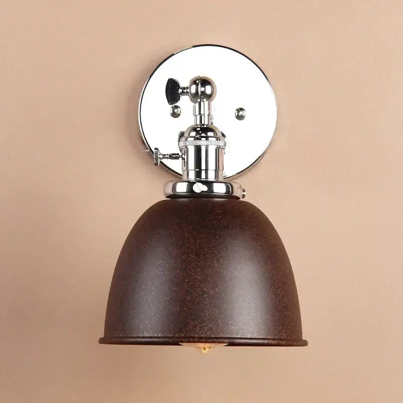 Brown textured metal dome wall sconce with polished chrome mounting plate and adjustable arm for industrial bedroom lighting