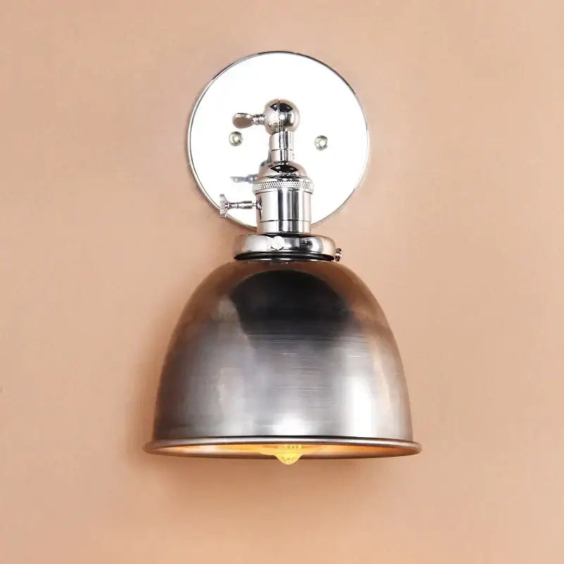 Industrial chrome and black wall sconce lights with a brushed metallic finish and a domed shade for bedroom use