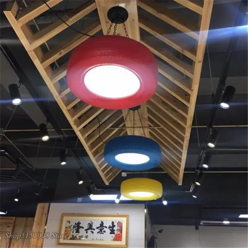 Red rubber industrial rubber tire pendant light by decorbites with bright white illuminated center for bar and kitchen décor