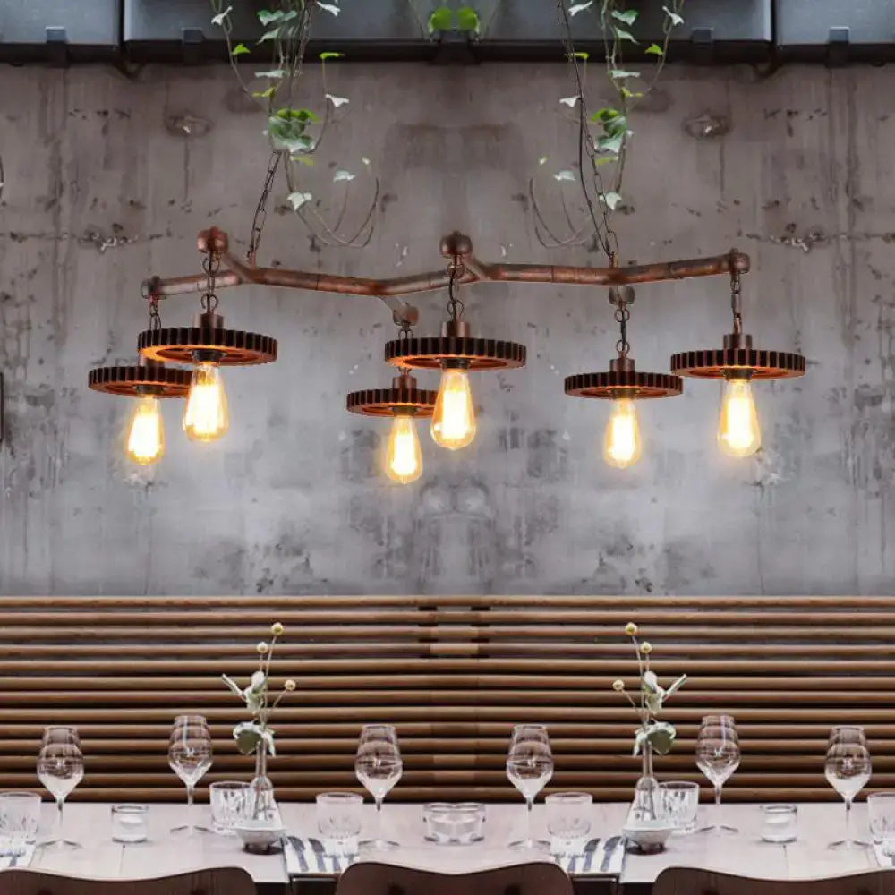 Industrial copper metal island lamp with five exposed edison bulbs and gear-shaped metal shades for dining room use