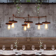 Industrial copper metal island lamp with five exposed edison bulbs and gear-shaped metal shades for dining room use