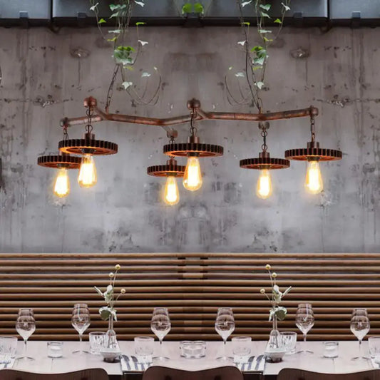 Industrial copper metal island lamp with five exposed edison bulbs and gear-shaped metal shades for dining room use