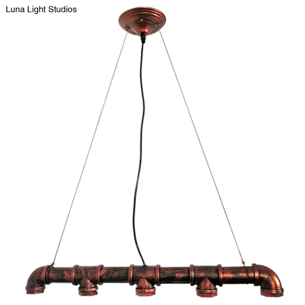 Industrial copper water pipe chandelier light fixture with rustic weathered finish and visible joints for dining room use