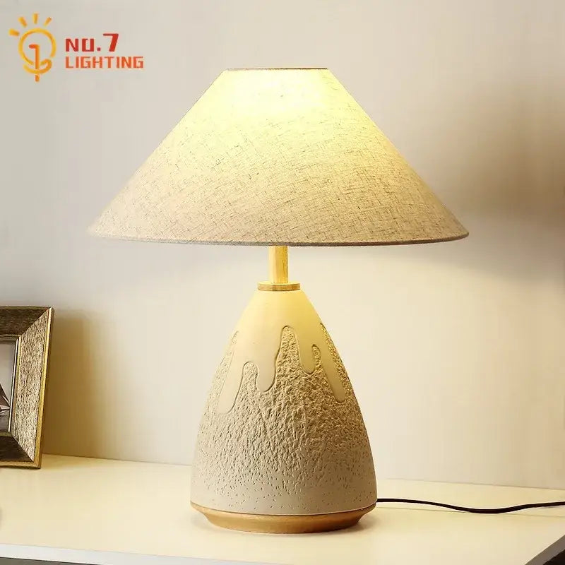 Cream-colored ceramic table lamp with textured teardrop base and beige shade for decorbites concrete led table