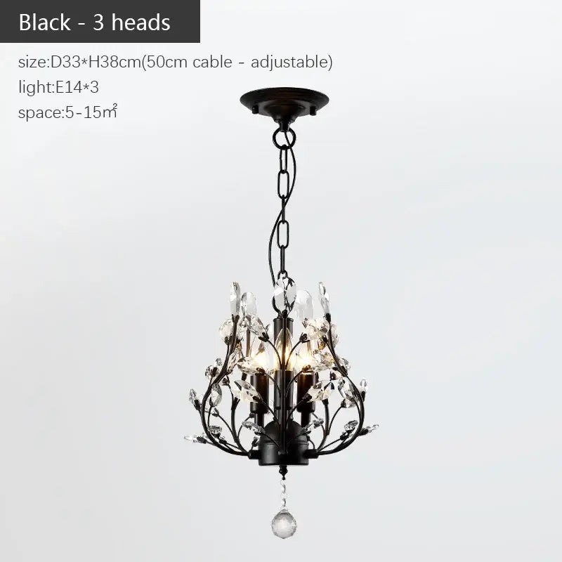 Black wrought iron decorbites industrial crystal chandelier with three candle-style lights and crystal accents in antique bronze
