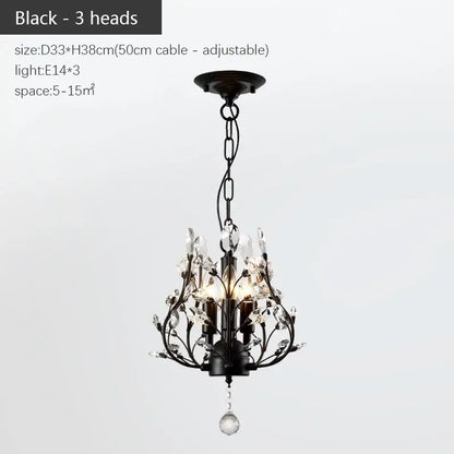 Black wrought iron decorbites industrial crystal chandelier with three candle-style lights and crystal accents in antique bronze
