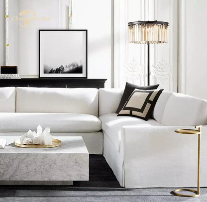 White sectional sofa with soft upholstery next to decorbites industrial crystal led black chrome floor lamp in living room