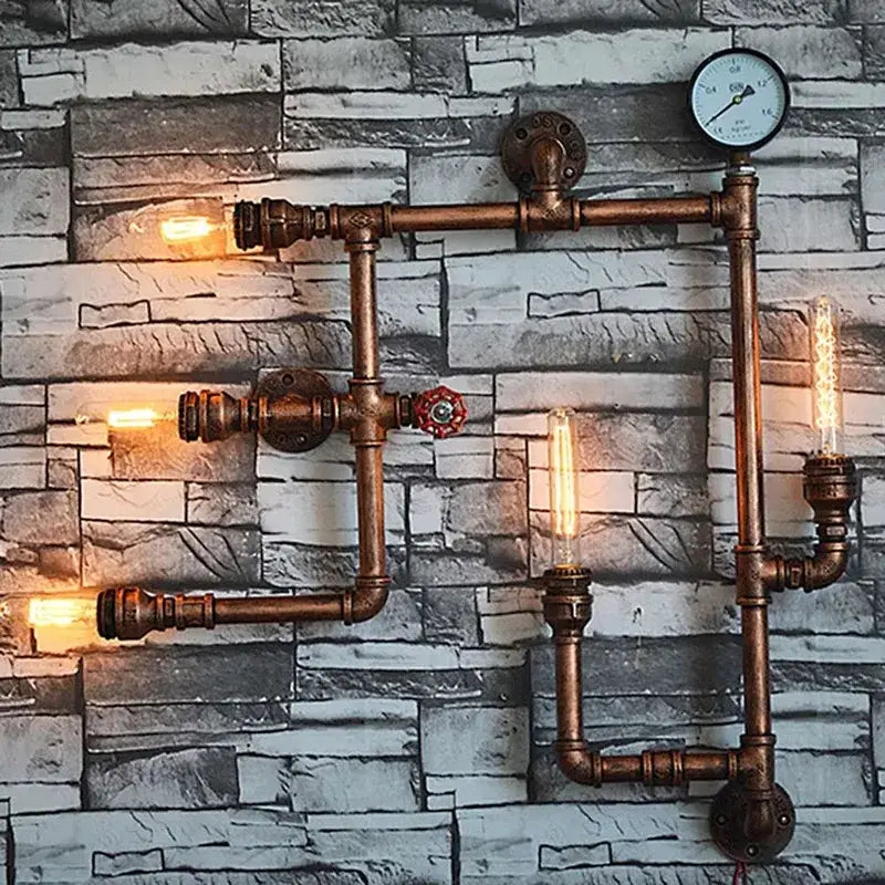 Industrial dark brass pipe wall lights featuring copper-colored pipes, exposed edison bulbs, and a pressure gauge sconce
