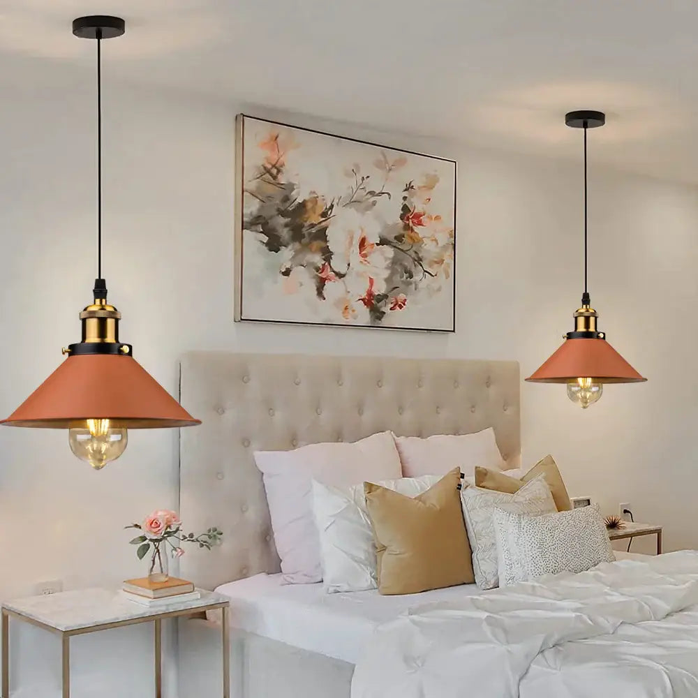 Two industrial farmhouse brown pendant lights with copper shades and brass accents hang above a kitchen island