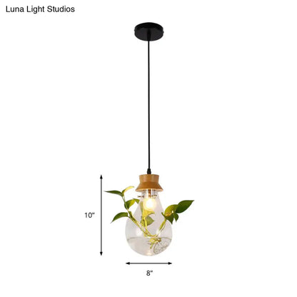 Industrial glass and wood pendant light kit with clear glass, wooden cap, exposed bulb, and vine for dining room use