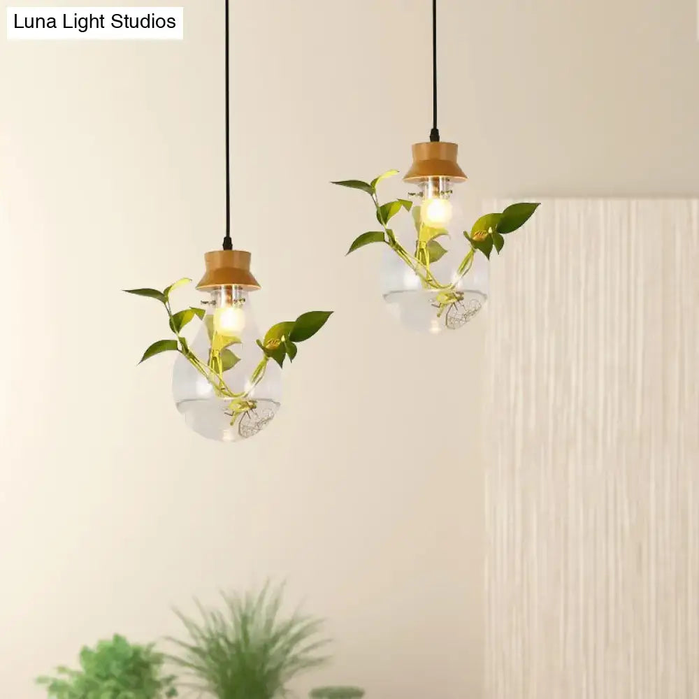 Industrial glass and wood pendant light kit with clear glass exposed bulb and green vines for dining room lighting