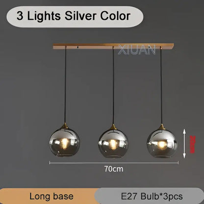 Silver-colored industrial glass pendant light with three spherical globes hanging from a wooden bar for kitchen decorbites industrial glass