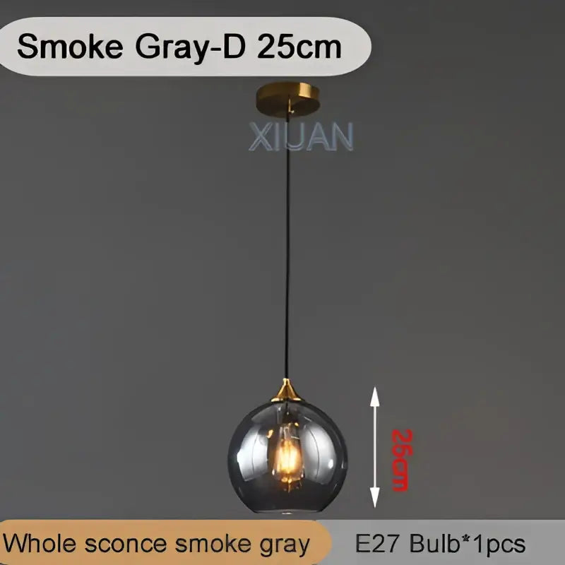 Smoke gray spherical glass pendant light with brass fixture and black cord decorbites industrial glass pendant design