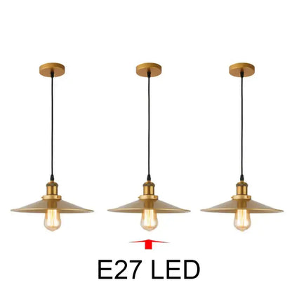 Set of three brass-finished industrial-style pendant lights with conical shades and exposed edison bulbs gold wrought iron decorbites pendant light