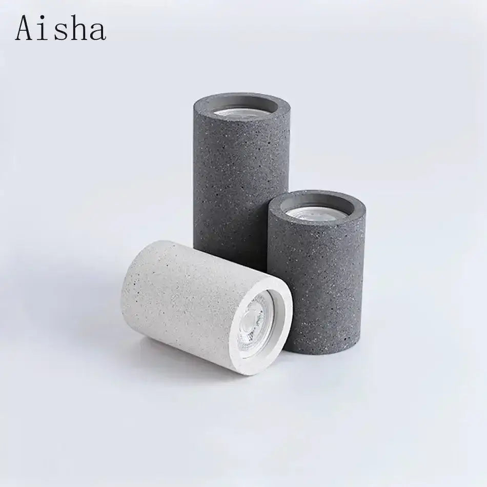 Set of three gray and white cylindrical concrete ceiling lights with speckled texture and visible led bulbs for kitchen decorbites industrial led ceiling