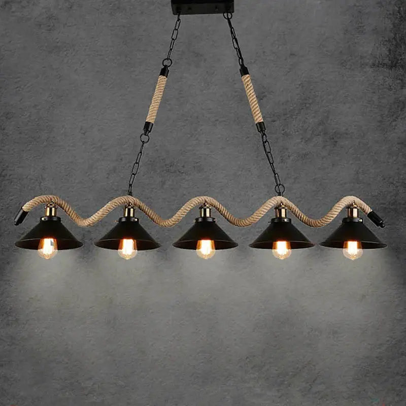 Industrial hemp rope pendant light with four black metal conical shades and exposed bulbs suspended by beige rope decorbites industrial hemp