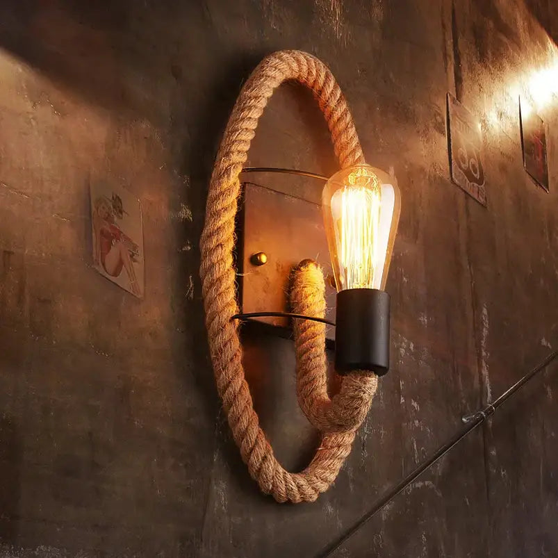 Industrial hemp rope wall lamp with exposed filament bulb emitting warm glow perfect for living room decorbites hemp rope