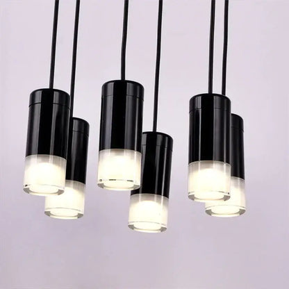 Black cylindrical pendant light with frosted glass base emitting soft white glow decorbites industrial iron art design