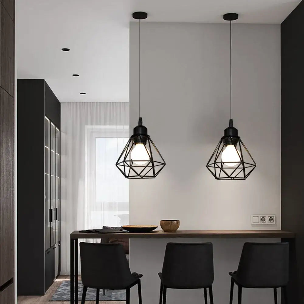 Black iron cage pendant lamp with geometric design hanging above dining table for decorbites industrial iron decor