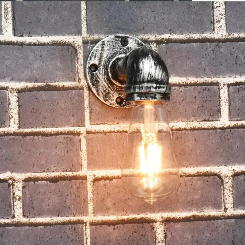 Industrial iron pipe wall sconce with blackened metal pipe and brass filament bulb for bedroom decorbites industrial iron lighting
