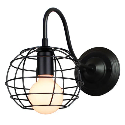 Black wrought iron wall sconce with cage design and warm glowing bulb by decorbites industrial iron wall fixture