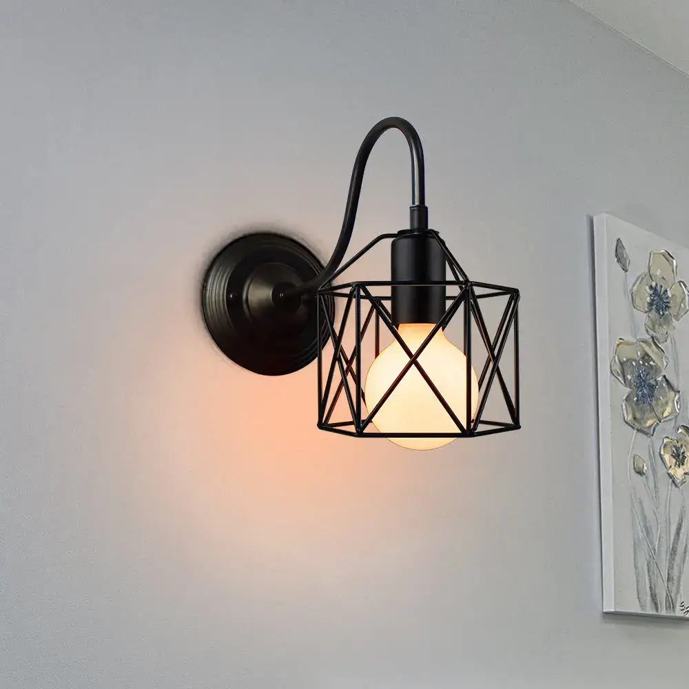 Black wrought iron wall sconce with geometric cage design and warm bulb for decorbites industrial iron wall decor