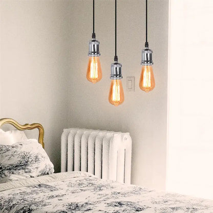 Three hanging vintage-style edison pendant light with warm amber glass and chrome fixtures for decorbites industrial loft
