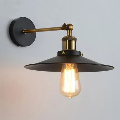Industrial loft led cage wall light sconce with black metal shade brass accents and exposed filament bulb for decorbites industrial loft