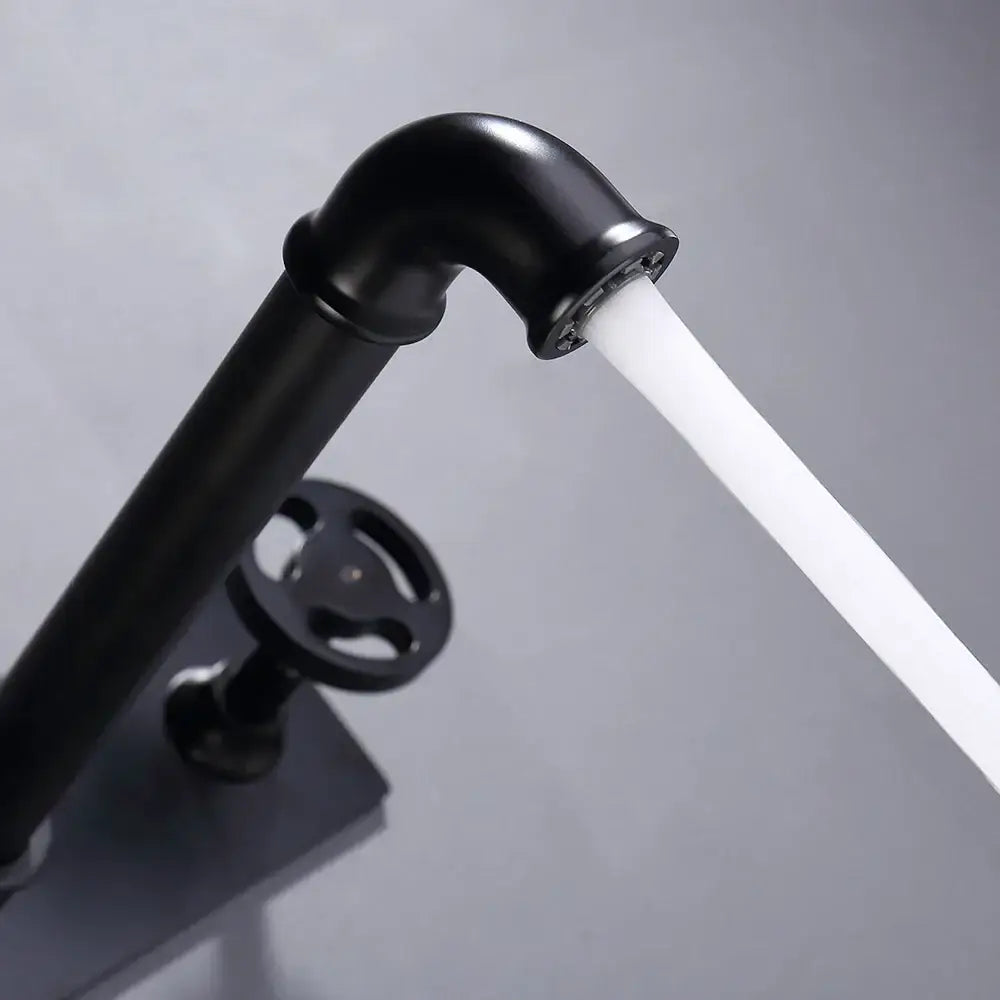 Industrial matte black dual handles basin faucet with curved spout and round handwheel decorbites industrial style