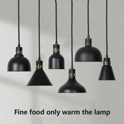 Industrial matte black pendant lamps with textured cords designed for electric food heat preservation in kitchens
